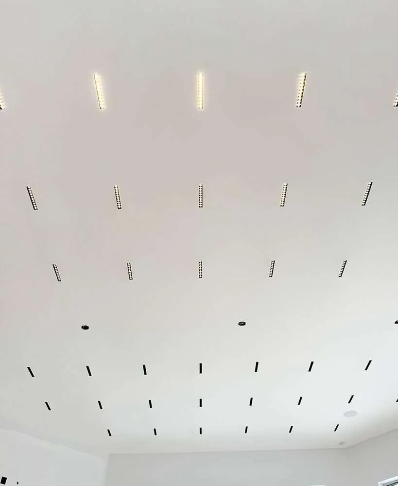 ceiling with multiple recessed linear lights installed in a grid pattern