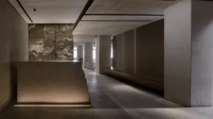Minimalist interior corridor with recessed architectural lighting and textured stone walls