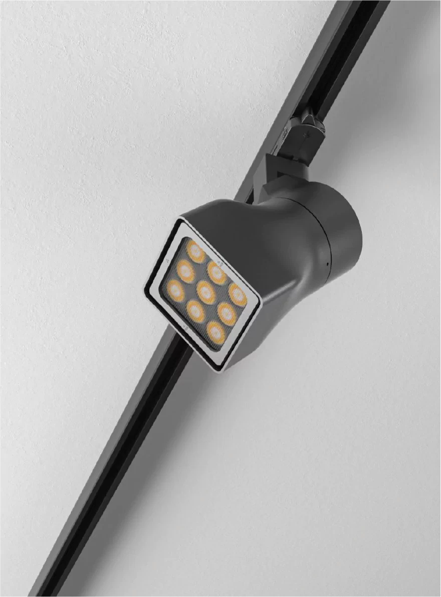 Black LED track light spotlight with square multi-lens head mounted on ceiling track