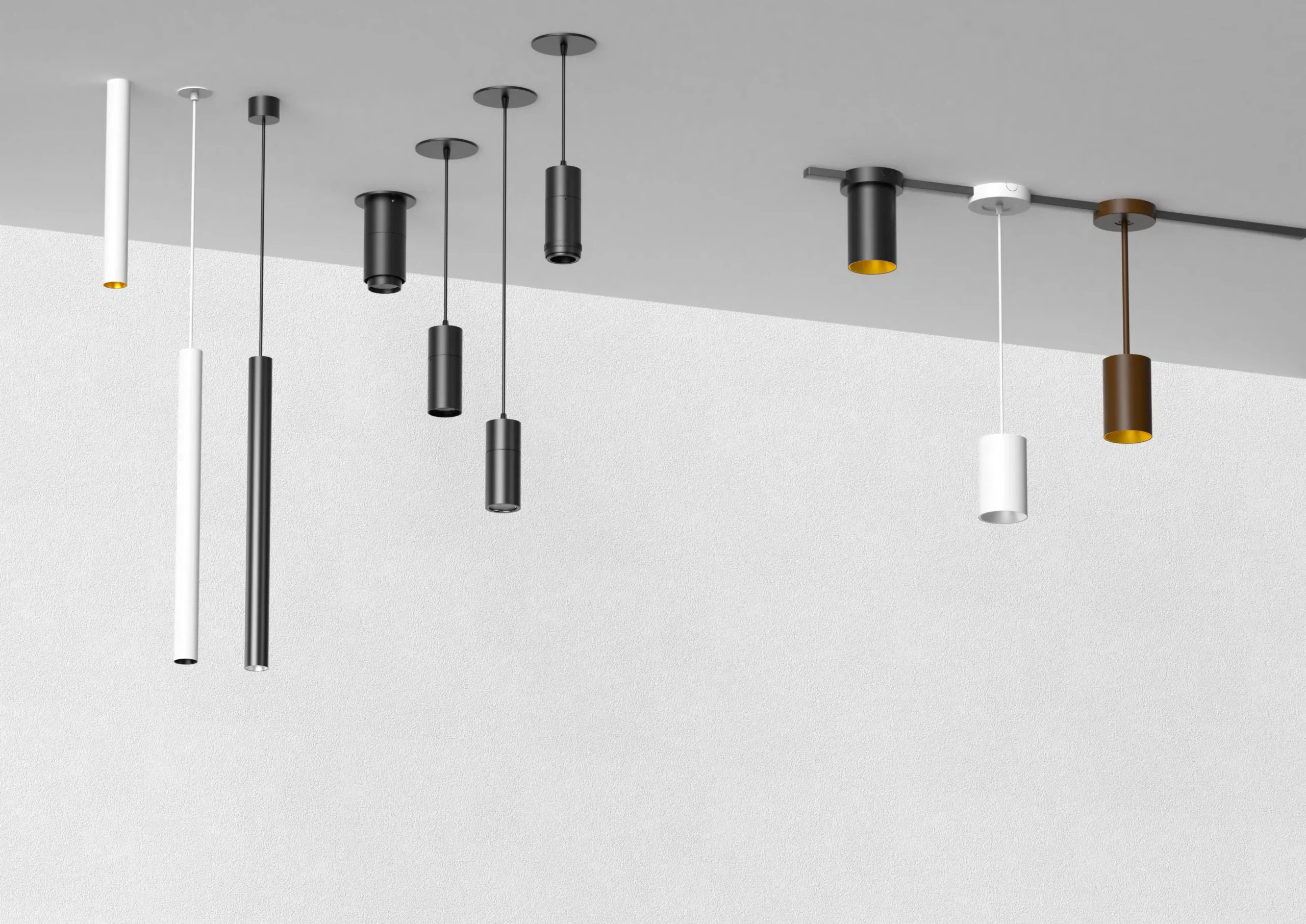 Minimalist cylindrical pendant lights in black, white, and brass mounted on ceiling